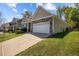 Charming single-Gathering home boasts a well-manicured lawn, stone accents, and a two-car garage at 112 Pink Dogwood Ln, Mebane, NC 27302