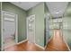 Hallway with hardwood floors leading to bathroom and carpeted bedroom in home at 112 Pink Dogwood Ln, Mebane, NC 27302