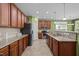 Stylish kitchen featuring wooden cabinetry, granite countertops and stainless steel appliances at 112 Pink Dogwood Ln, Mebane, NC 27302