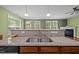 This kitchen features an eat-in bar with a dual sink basin and a view of the living space at 112 Pink Dogwood Ln, Mebane, NC 27302