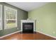 Living room boasts a fireplace and ample natural light from large windows at 112 Pink Dogwood Ln, Mebane, NC 27302