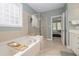 Elegant bathroom with separate shower, soaking tub, and seamless access to the bedroom at 1120 Scholastic Cir, Durham, NC 27713