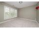 Bedroom with a neutral color scheme, large window, and ample natural light at 1120 Scholastic Cir, Durham, NC 27713