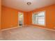 Spacious bedroom featuring an adjacent bathroom and a sunlit window at 1120 Scholastic Cir, Durham, NC 27713