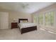 Well-lit bedroom with three windows and neutral carpet at 1120 Scholastic Cir, Durham, NC 27713
