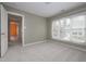 Bedroom featuring a large window and a doorway leading to additional rooms at 1120 Scholastic Cir, Durham, NC 27713