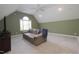 Bonus room featuring a couch, TV, and a large window for natural light at 1120 Scholastic Cir, Durham, NC 27713