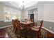 Formal dining room with a chandelier and large windows at 1120 Scholastic Cir, Durham, NC 27713