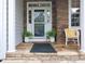 Charming front porch entrance featuring stone accents and a welcoming seating arrangement at 1120 Scholastic Cir, Durham, NC 27713