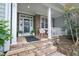 Welcoming front porch with stone details, potted plants, and comfortable seating area at 1120 Scholastic Cir, Durham, NC 27713