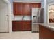 Spacious kitchen with stainless steel refrigerator, granite counters and tiled backsplash at 1120 Scholastic Cir, Durham, NC 27713