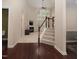 Inviting living room with a fireplace, large windows, and a staircase leading to the second floor at 1120 Scholastic Cir, Durham, NC 27713