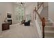 Spacious living room with soaring ceilings, large windows, a fireplace, and staircase at 1120 Scholastic Cir, Durham, NC 27713