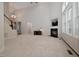 Spacious living room with a fireplace, high ceilings, and a staircase leading to the second floor at 1120 Scholastic Cir, Durham, NC 27713