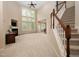 Bright living room featuring a fireplace, large windows offering natural light, and a staircase at 1120 Scholastic Cir, Durham, NC 27713