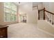 Open living room with a fireplace, lots of natural light, and a staircase leading to the upper level at 1120 Scholastic Cir, Durham, NC 27713
