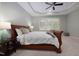 Tranquil main bedroom with a tray ceiling, a fan, and a large window offering natural light at 1120 Scholastic Cir, Durham, NC 27713