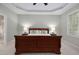 Serene main bedroom with a tray ceiling, soft lighting, and comfortable furnishings at 1120 Scholastic Cir, Durham, NC 27713