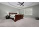 Comfortable main bedroom featuring a tray ceiling, fan, and a large window offering natural light at 1120 Scholastic Cir, Durham, NC 27713
