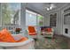 Enjoy the screened in porch with views and comfortable, bright-colored furniture at 1120 Scholastic Cir, Durham, NC 27713