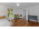 Light-filled bedroom with a play area, hardwood floors, and neutral decor at 116 W Front St, Oxford, NC 27565
