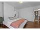Large bedroom with neutral decor, hardwood floors, white walls, and an open doorway at 116 W Front St, Oxford, NC 27565