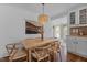 Dining room with hardwood floors, modern lighting, a tapestry, and an open view of the kitchen at 116 W Front St, Oxford, NC 27565