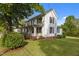 Charming two-story home with lush lawn and a cozy porch, set amidst beautiful greenery at 116 W Front St, Oxford, NC 27565