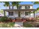Charming two-story home featuring a classic front porch, complemented by manicured landscaping at 116 W Front St, Oxford, NC 27565