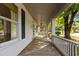 Charming front porch with detailed columns, long area for furniture and relaxing at 116 W Front St, Oxford, NC 27565