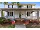 Inviting two-story home with a classic front porch, featuring black shutters and a brick staircase at 116 W Front St, Oxford, NC 27565