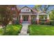 Beautiful bungalow with a manicured front lawn and vibrant red accents on the porch columns at 116 W Front St, Oxford, NC 27565
