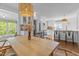 Bright, open concept kitchen with a dining table, stainless steel appliances, and white cabinets at 116 W Front St, Oxford, NC 27565