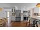 Modern kitchen with stainless steel appliances, butcher block countertops, white cabinetry, and hardwood flooring at 116 W Front St, Oxford, NC 27565