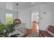 A cozy landing with a woven pendant light, indoor plant, and an inviting view into the next room at 116 W Front St, Oxford, NC 27565