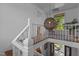 Second floor landing with wood floors, white walls, and stairway view at 116 W Front St, Oxford, NC 27565