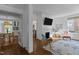 Open-concept living room with hardwood floors, decorative fireplace, and access to dining area and kitchen at 116 W Front St, Oxford, NC 27565