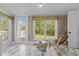 Bright sunroom with tile flooring and large windows overlooking the landscaped exterior at 116 W Front St, Oxford, NC 27565