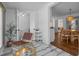 Bright sitting area featuring a woven seat chair and an open doorway to the dining area at 116 W Front St, Oxford, NC 27565
