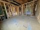 Unfinished bedroom showing the framed walls, studs, and underlayment at 12 Gates St, Roxboro, NC 27573