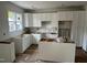 Bright kitchen with white cabinetry, a large window, and an open layout ready for appliances at 12 Gates St, Roxboro, NC 27573