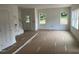 Spacious living room featuring natural light from three windows and a door to the outside at 12 Gates St, Roxboro, NC 27573