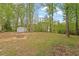 Large, wooded backyard with a fire pit and shed at 120 Kerigon Ln, Youngsville, NC 27596