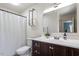Well-lit bathroom with vanity sink, a shower with curtain, and towel rack at 120 Kerigon Ln, Youngsville, NC 27596