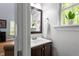 Bathroom featuring a classic vanity, framed mirror, and bright natural light at 120 Kerigon Ln, Youngsville, NC 27596