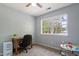 Bedroom with a ceiling fan, large window, desk, chair, and various toys at 120 Kerigon Ln, Youngsville, NC 27596