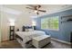 Bright bedroom with a ceiling fan and large windows offering an outdoor view at 120 Kerigon Ln, Youngsville, NC 27596