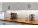 Close-up of butcher block countertop featuring white cabinets and stainless steel appliances at 120 Kerigon Ln, Youngsville, NC 27596