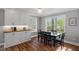 Dining area featuring hardwood floors, white cabinets, and large windows for lots of light at 120 Kerigon Ln, Youngsville, NC 27596