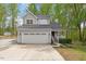 Charming two-story home with a well-maintained front yard, large garage, and inviting front porch at 120 Kerigon Ln, Youngsville, NC 27596